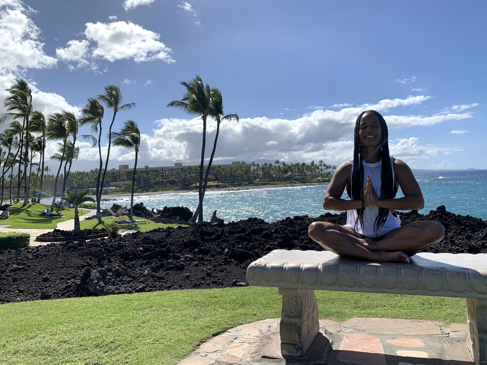 Dana Macc meditating by the ocean in Kona, Hawaii